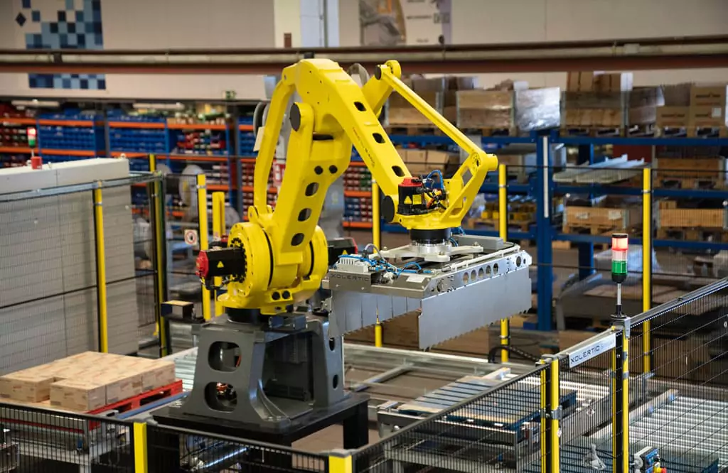 Foto cobots amarillo realizando tareas de paletizado / despaletizado en fábrica